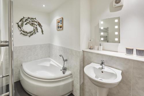 a white bathroom with a toilet and a sink at Host & Stay - Fox's Hideout in Whitby