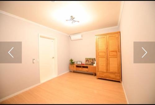 an empty living room with a ceiling fan and a door at Moon Drawing Goeun in Chuncheon