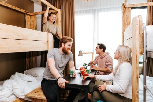 a group of people sitting around a table in a bedroom at The Hague Teleport Hotel in The Hague