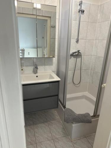 a bathroom with a sink and a shower at Downtown Chic Apartment Graz - Top 8 self check-in in Graz