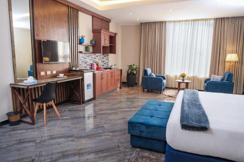 um quarto de hotel com uma cama e uma sala de estar em South Gate Hotel Apartment em Addis Ababa