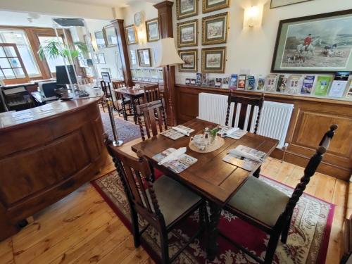 a dining room with a table and a bar at The Black Horse Inn in Canterbury