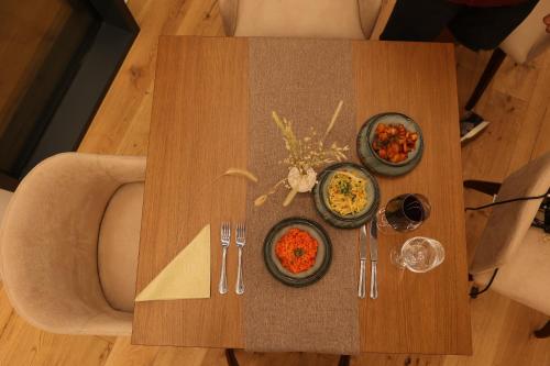 a table with two plates of food on it at City Hotel Glarnerland in Näfels