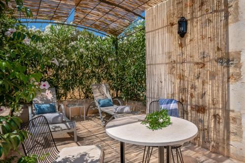a patio with a table and chairs and a fence at Agroturismo Son Siurana in Alcudia