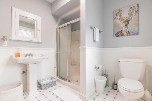 a bathroom with a shower and a toilet and a sink at Beach Block-Ocean Views from Balconies-Parking Unit 2 in Ventnor City
