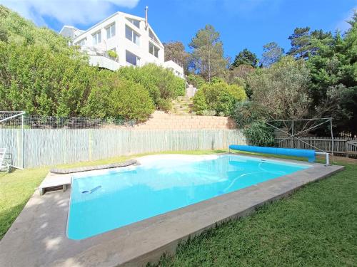 a swimming pool in the yard of a house at Mount Rhodes Guesthouse, three separate units, please select either three bedroom, two and a half bedroom or one bedroom in Cape Town
