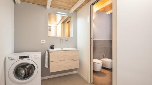 a bathroom with a washing machine and a sink at Classbnb - Due moderni appartamenti a 1km dall'Arco della Pace in Milan