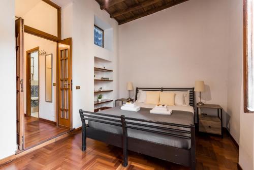 a bedroom with a bed and a wooden floor at Appartamento vicolo delle Grotte in Rome