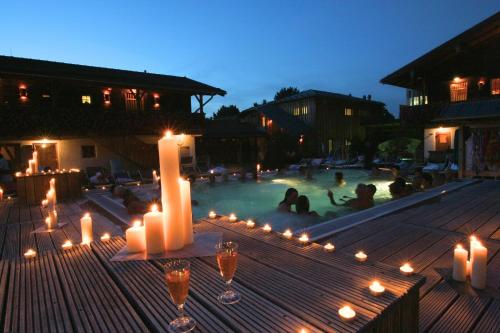 a group of people sitting in a swimming pool with candles at Aqua Blu Hotel in Bad Füssing