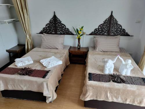 Un pat sau paturi într-o cameră la Tahnboon-ทานบุณ