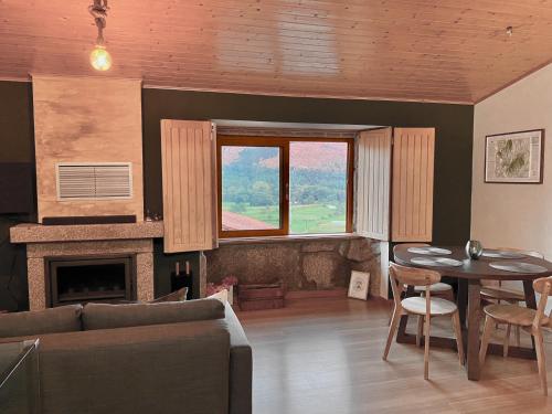 a living room with a couch and a table at Green Man Gerês Mountain House in Campo do Gerês