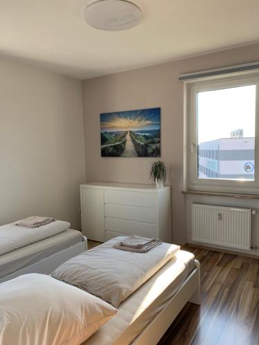 a bedroom with two beds and a window at Apartment Rebe in Schweinfurt