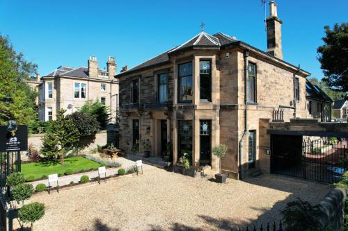 a large brick house with a courtyard in front of it at 23 Mayfield in Edinburgh