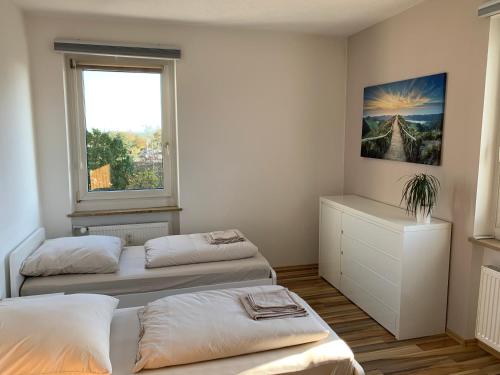 a bedroom with two beds and a window at Apartment Rebe in Schweinfurt
