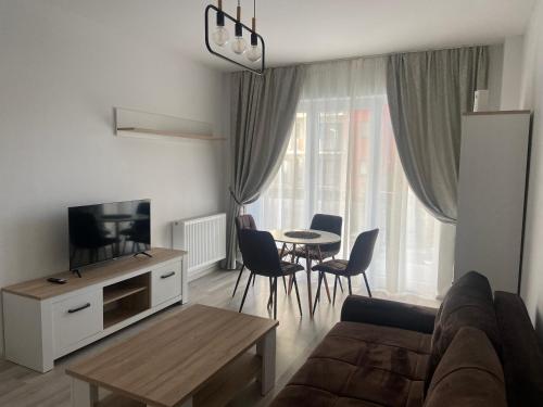 a living room with a couch and a table at Divany Apartament in Braşov