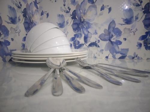 a table with plates and utensils and a egg on it at freedom house in Unawatuna