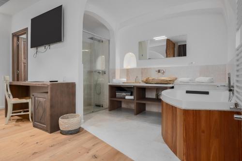 a white bathroom with a sink and a shower at Il Giardino Degli Aranci in Mores