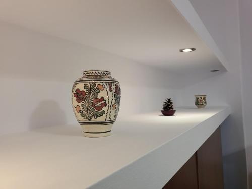 a vase sitting on a counter in a room at Casa Rezidentiala Aria in Cluj-Napoca