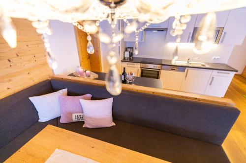 a kitchen with pink and white pillows in a room at Ferienanlage Central in Flachau