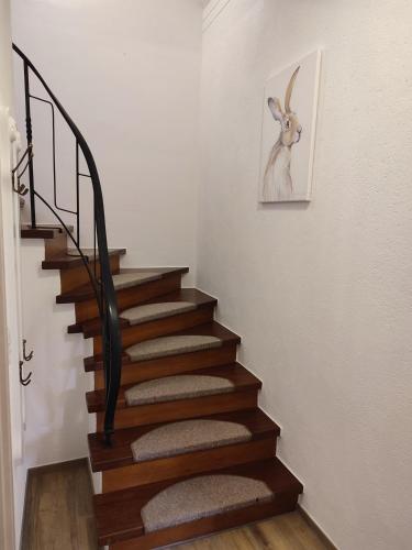 a stairway with a picture of a goat on the wall at Ferienwohnung Fuchs & Hase in Kronenburg
