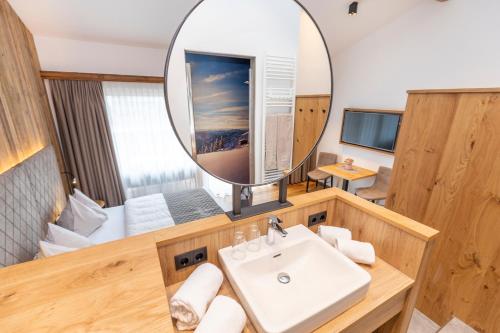 a bathroom with a sink and a mirror at Ferienanlage Central in Flachau
