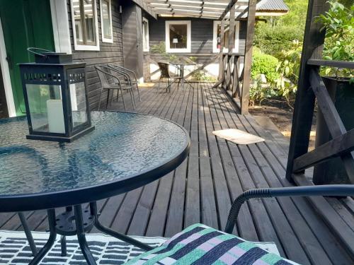 a patio with two tables and chairs on a deck at Lodge Tenis Pucon cl in Pucón