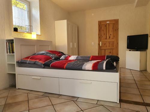 a bedroom with a large bed with a tv on it at Belroki Ranch in Waldeck