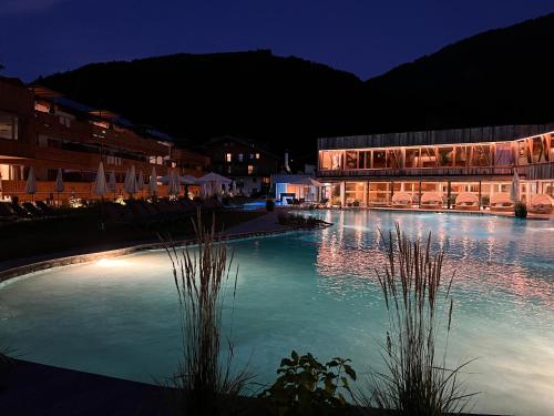 a large pool of water in front of a building at Ferienanlage Central in Flachau