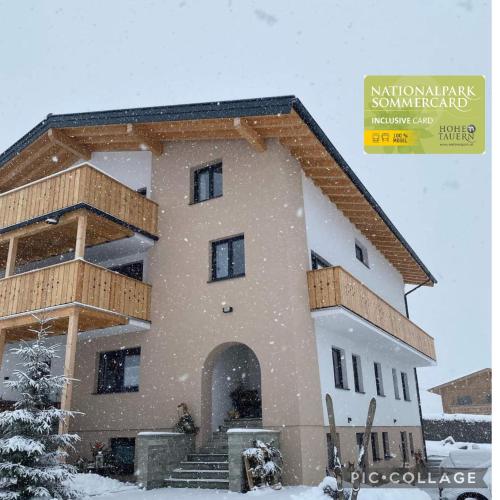 a building covered in snow with a sign that reads national park summit park at Appartements Kumming - Urlaub inklusive Nationalparkcard in Rauris