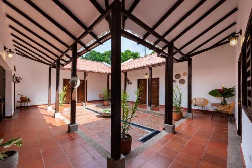 an open courtyard with a large wooden structure with potted plants at La Mello Adventure Lodge in Palomino