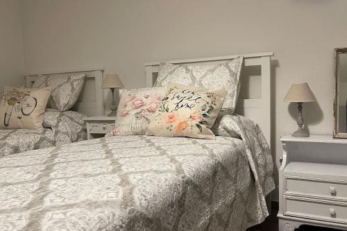 una camera da letto con un letto bianco con fiori sopra di Antica Dimora PT a Coldrerio
