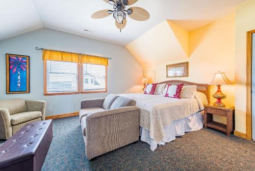 a bedroom with a bed and a couch at Silver Lining in Kill Devil Hills