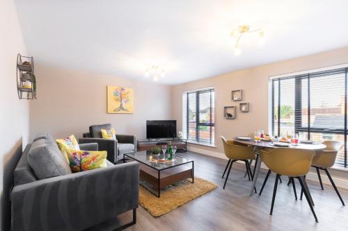 a living room with a couch and a table at Elliot Oliver - Luxurious Two Bedroom Apartment With Parking in Gloucester