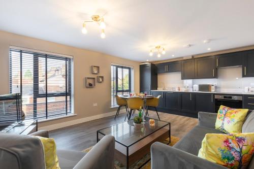 a living room with a couch and a table at Elliot Oliver - Luxurious Two Bedroom Apartment With Parking in Gloucester