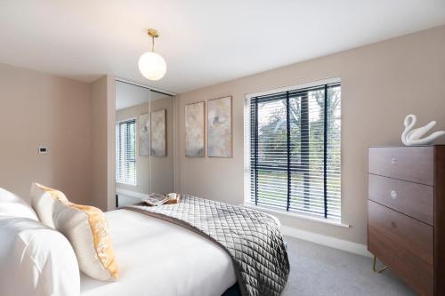 a bedroom with a bed and a large window at Elliot Oliver - Luxurious Two Bedroom Apartment With Parking in Gloucester