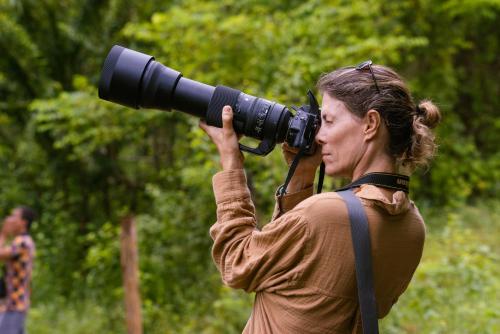 a woman is taking a picture with a camera at La Mello Country House in Palomino