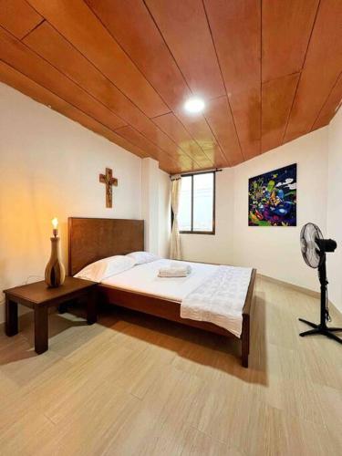 a bedroom with a bed and a cross on the ceiling at Hermoso Apto Con Vista a la Basílica in Buga