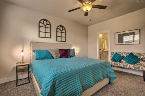 a bedroom with a bed and a ceiling fan at College Station Townhome with Furnished Patio! in College Station
