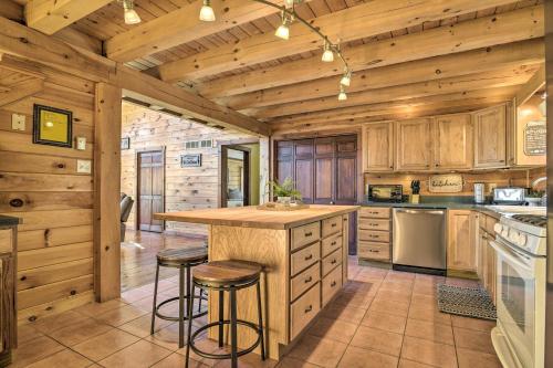 a kitchen with wooden walls and a counter with stools at Pool, Games and Sauna Mount Joy Countryside Cabin in Mount Joy