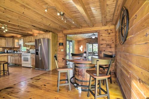 a kitchen with a bar in a log cabin at Pool, Games and Sauna Mount Joy Countryside Cabin in Mount Joy