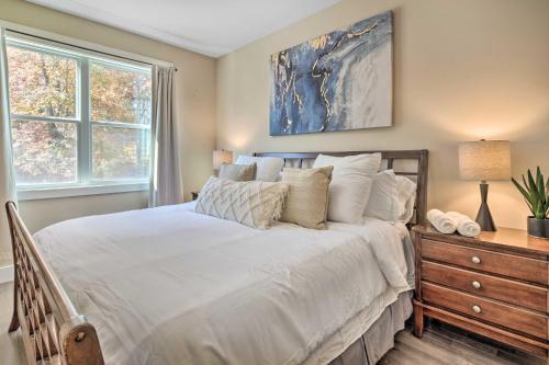 a bedroom with a large white bed and a dresser at Charming Asheville House with Private Yard! in Asheville
