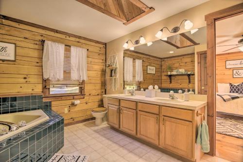 a bathroom with a tub toilet and a sink and a tubspective at Beautiful Mount Joy Cabin with Pool and Sauna! in Mount Joy