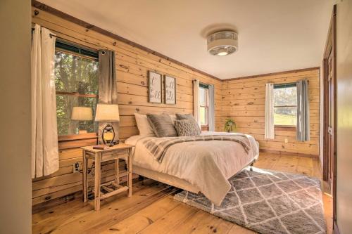 a bedroom with wooden walls and a bed and a table at Pool, Games and Sauna Mount Joy Countryside Cabin in Mount Joy