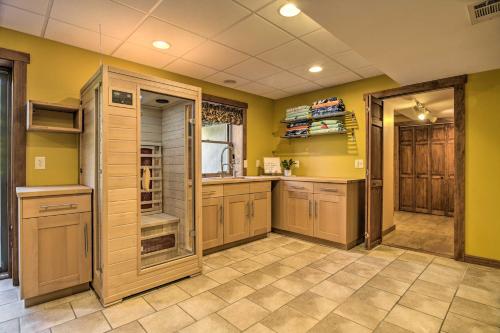 a large kitchen with yellow walls and wooden cabinets at Pool, Games and Sauna Mount Joy Countryside Cabin in Mount Joy