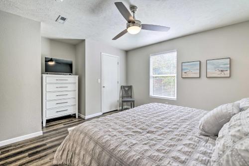 a bedroom with a bed and a ceiling fan at Branson Condo with Balcony Near Silver Dollar City in Branson