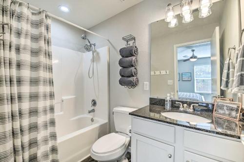 a bathroom with a toilet and a sink and a tub at Branson Condo with Balcony Near Silver Dollar City in Branson