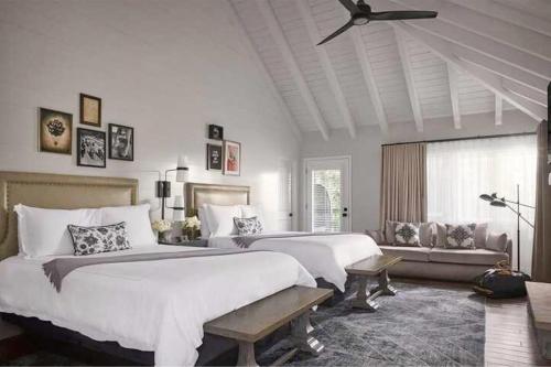 a bedroom with two beds and a ceiling fan at The Estate Yountville in Yountville