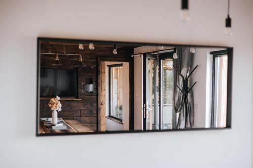 a mirror on a wall in a living room at Horse Park Hideaway, Luxury Hot Tub Glamping Retreat in Pilling