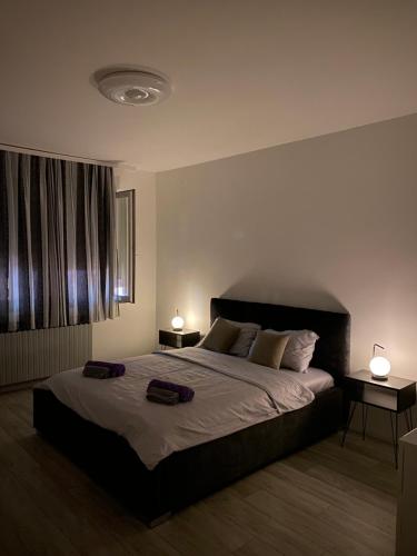 a bedroom with a large bed with two bags on it at Grand Royal in Belgrade