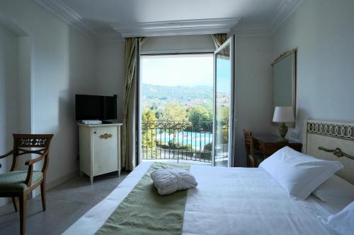 a bedroom with a bed and a large window at HOTIDAY Resort Fiuggi in Fiuggi
